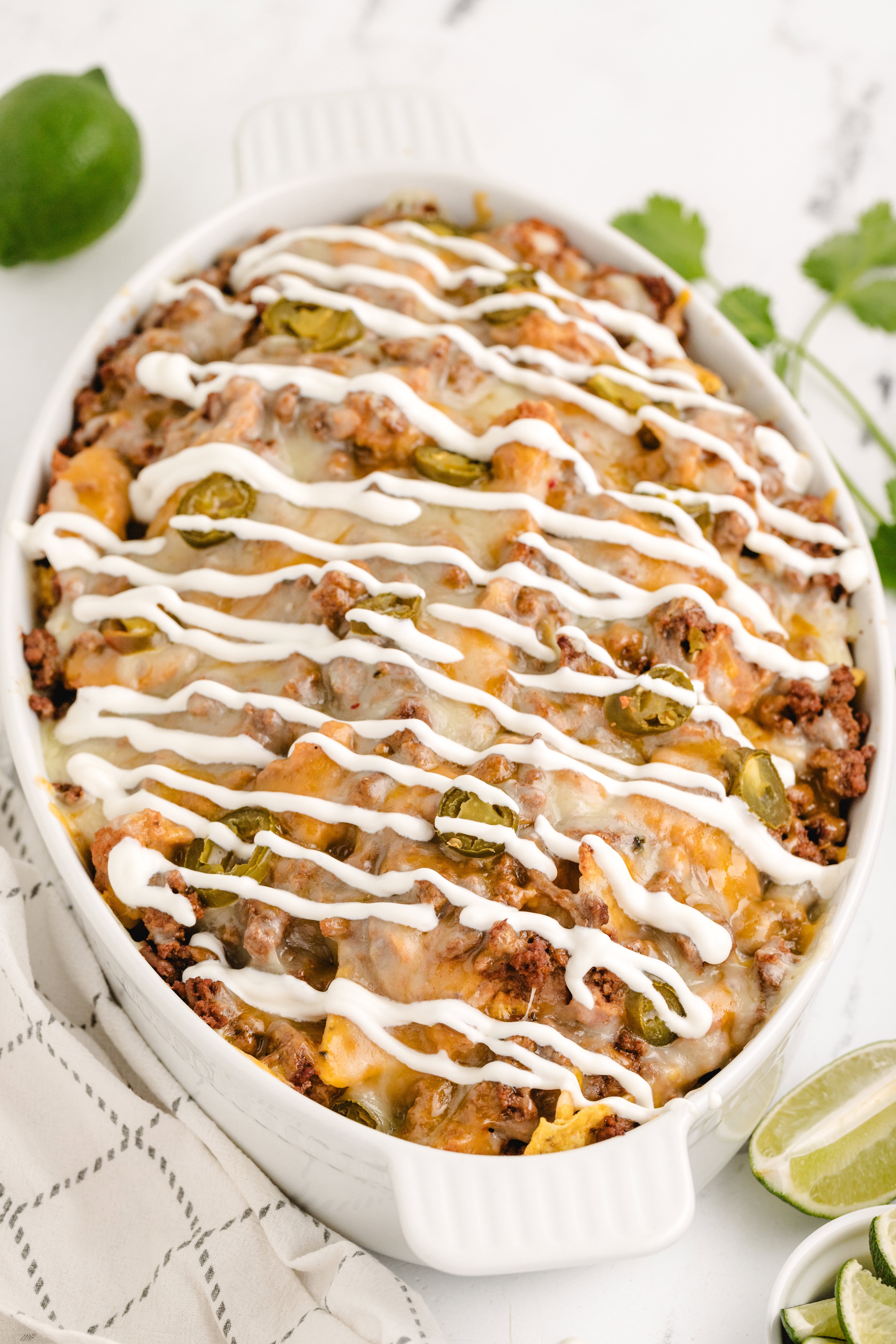 ground beef nachos drizzled with sour cream