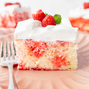slice of jello poke cake on a plate with fork