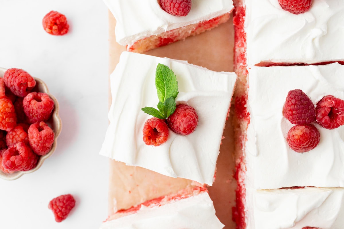 Easy Jello Poke Cake recipe from RecipeGirl.com : raspberry poke cake, strawberry poke cake overhead shot of slices of jello poke cak