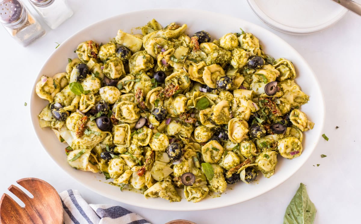 Pesto Tortellini Pasta Salad recipe from RecipeGirl.com serving dish of pesto tortellini pasta salad