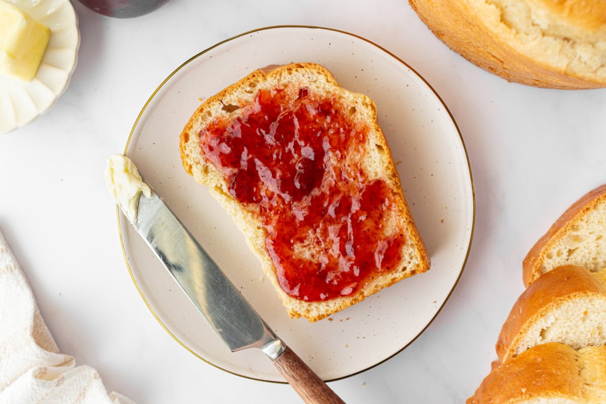 Sally Lunn bread is a soft, slightly sweet old-fashioned favorite yeast bread baked in a tube pan. Perfect for brunch or serving warm with butter and jam! Soft, buttery and so good. slice of sally lunn bread toasted with jam