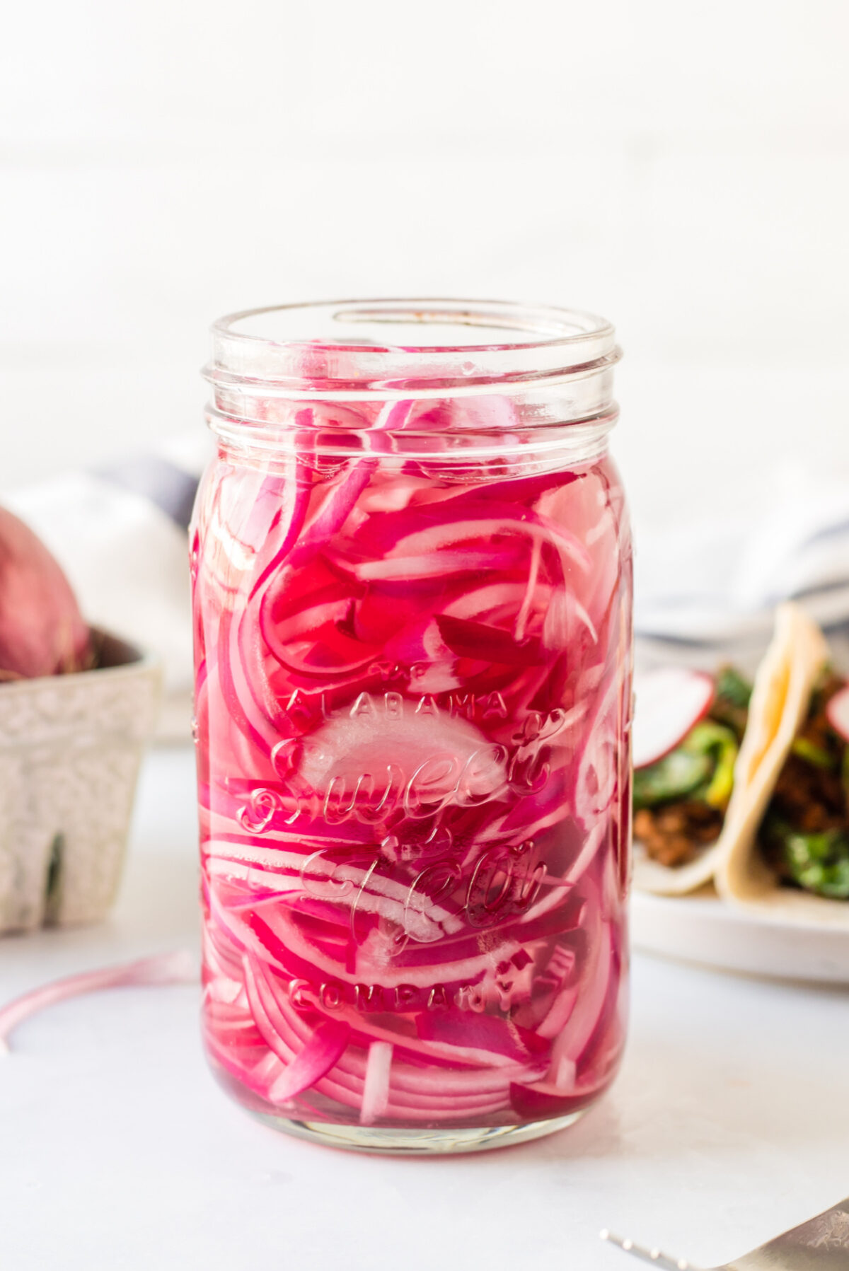 Quick Pickled Red Onions recipe from RecipeGirl.com : easy pickled onions side shot of jar of quick pickled red onions