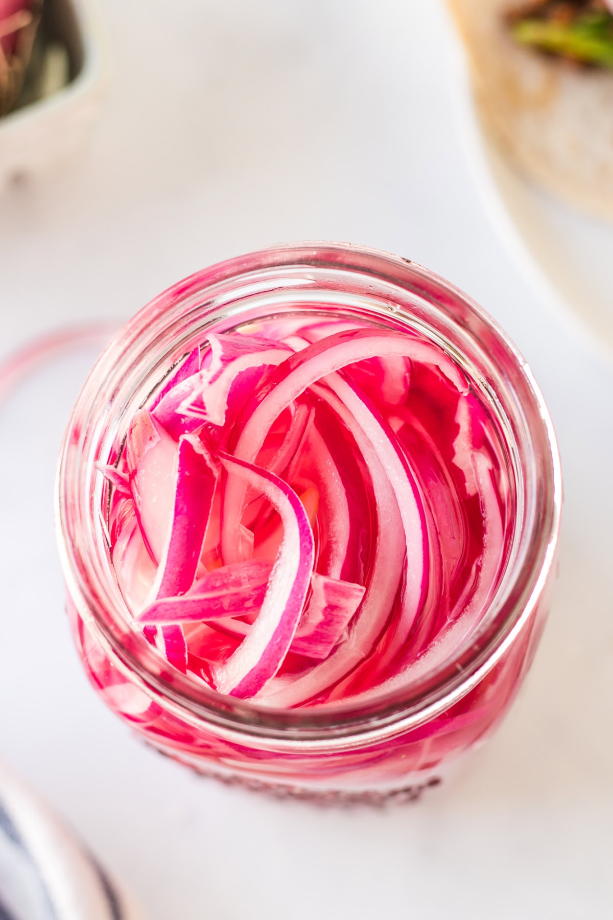 Quick Pickled Red Onions recipe from RecipeGirl.com : easy pickled onions overhead shot into jar of pickled red onions