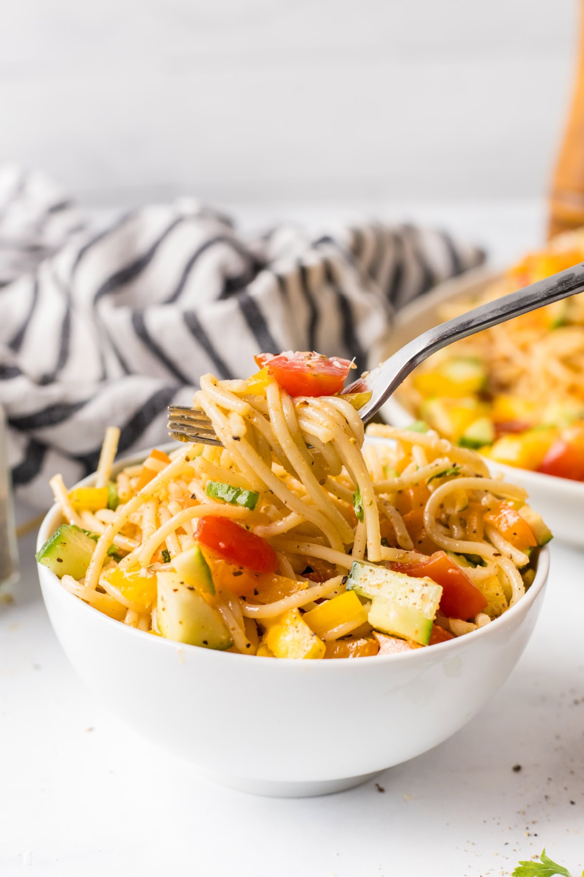 Cold Spaghetti Salad recipe from RecipeGirl.com : easy Italian pasta salad serving of spaghetti salad in a bowl with a fork