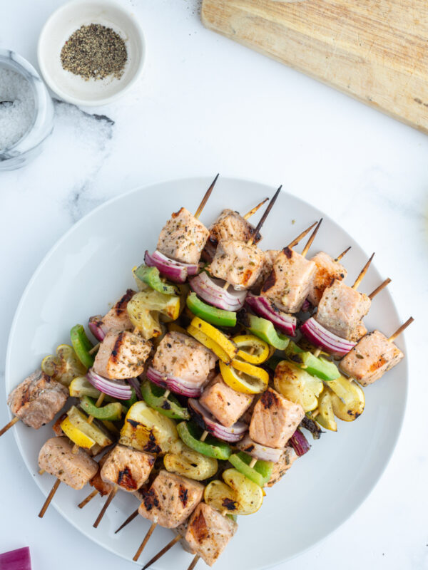 overhead shot of grilled salmon and veggie kabobs on plate