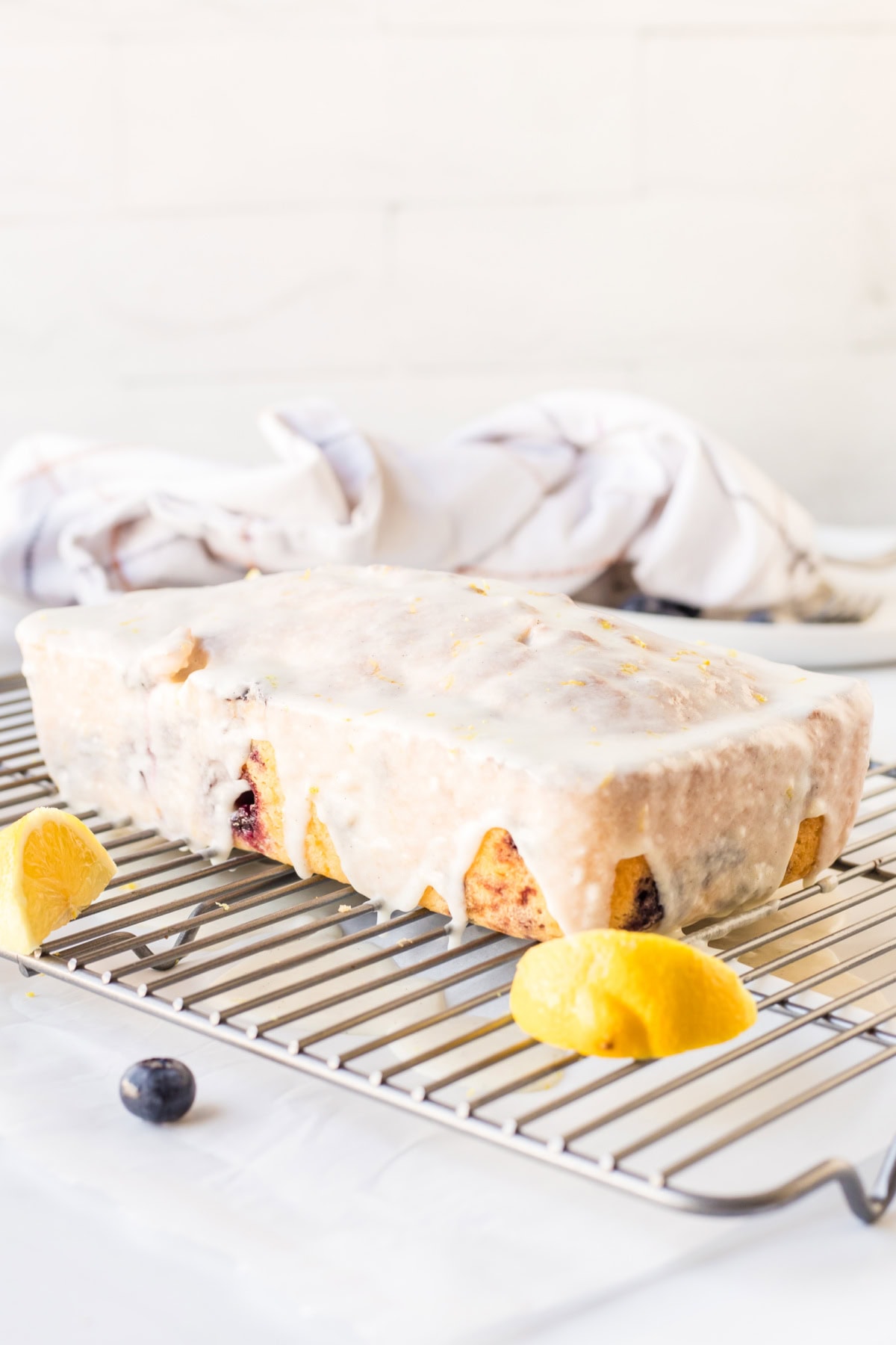 Glazed Lemon Blueberry Bread recipe from RecipeGirl.com : blueberry lemon loaf cake glazed lemon blueberry bread on cooling rack