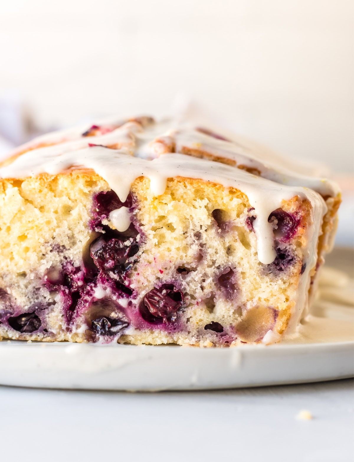 Glazed Lemon Blueberry Bread recipe from RecipeGirl.com : blueberry lemon loaf cake cut open loaf of lemon blueberry bread
