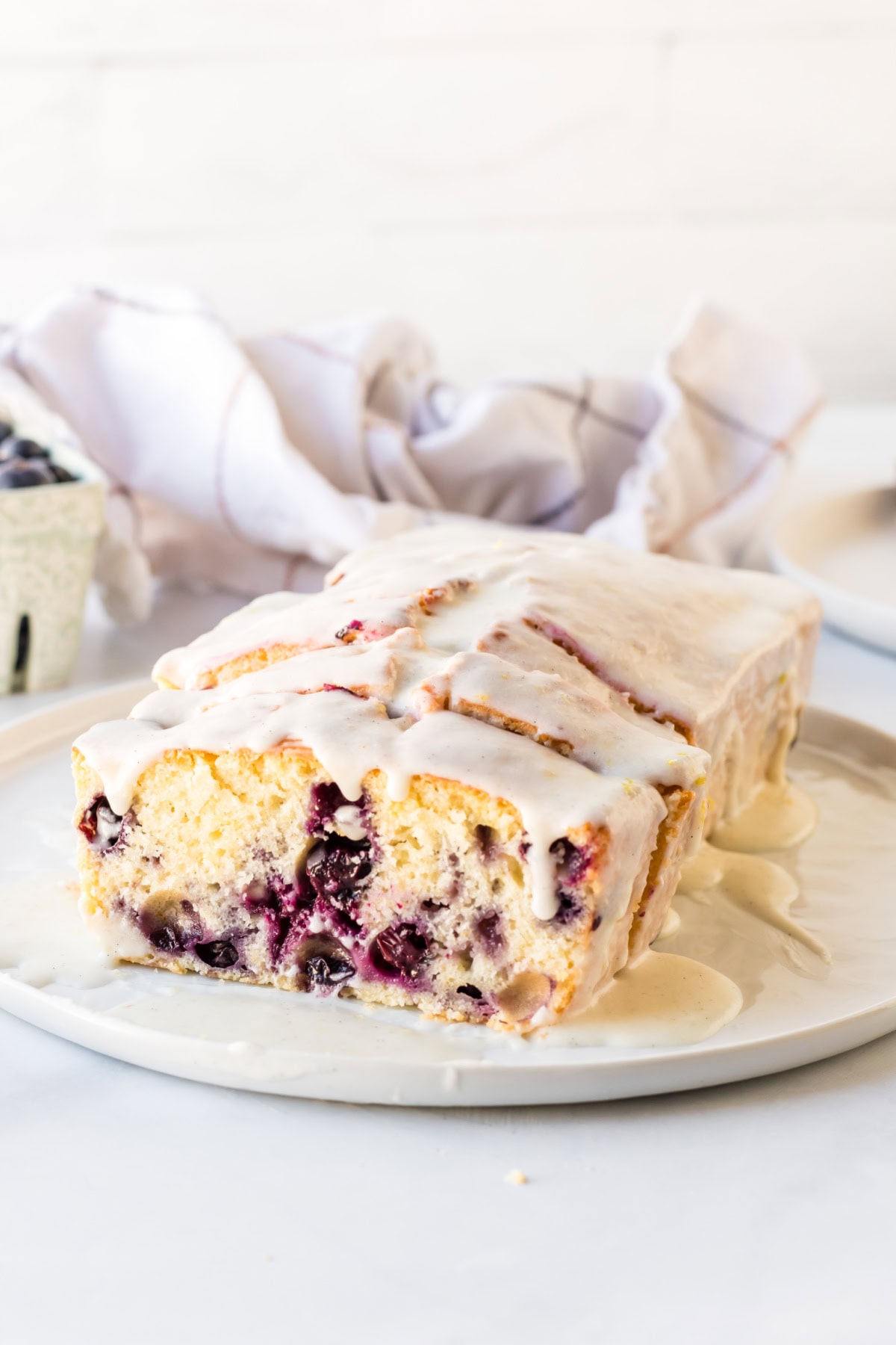 Glazed Lemon Blueberry Bread recipe from RecipeGirl.com : blueberry lemon loaf cake lemon blueberry bread glazed and sliced on plate
