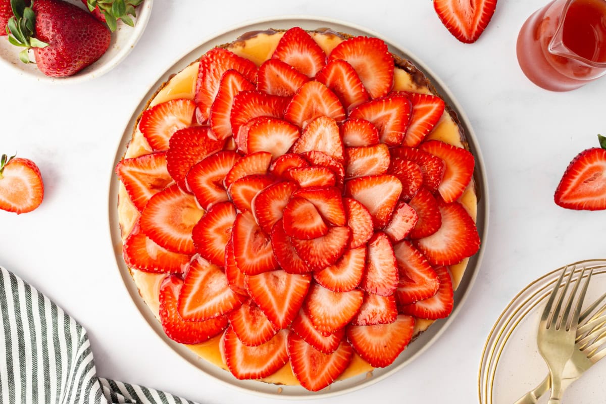 sliced strawberries on top of cheesecake