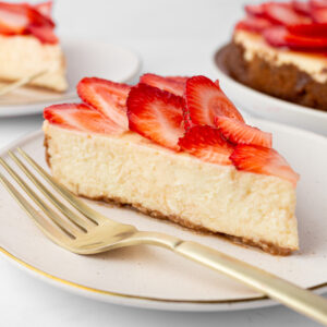 slice of strawberry cheesecake on a plate