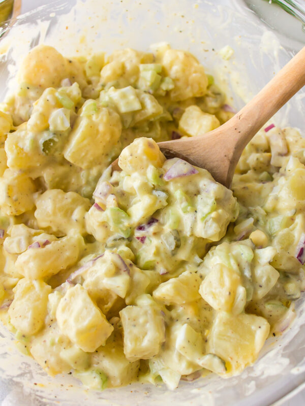 spoon in bowl of sweet pickle potato salad