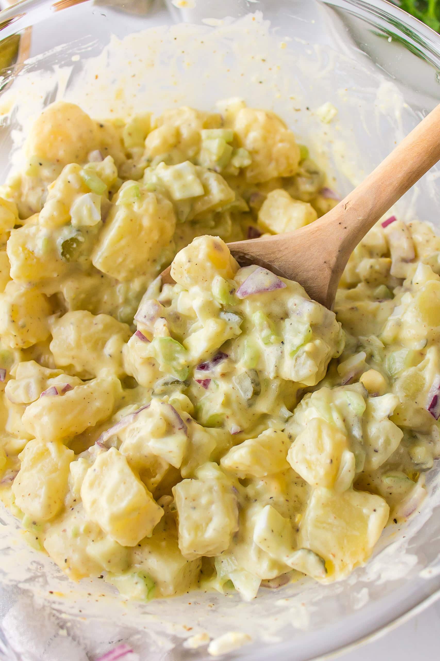 Sweet Pickle Potato Salad : a creamy potato salad recipe from RecipeGirl.com spoon in bowl of sweet pickle potato salad