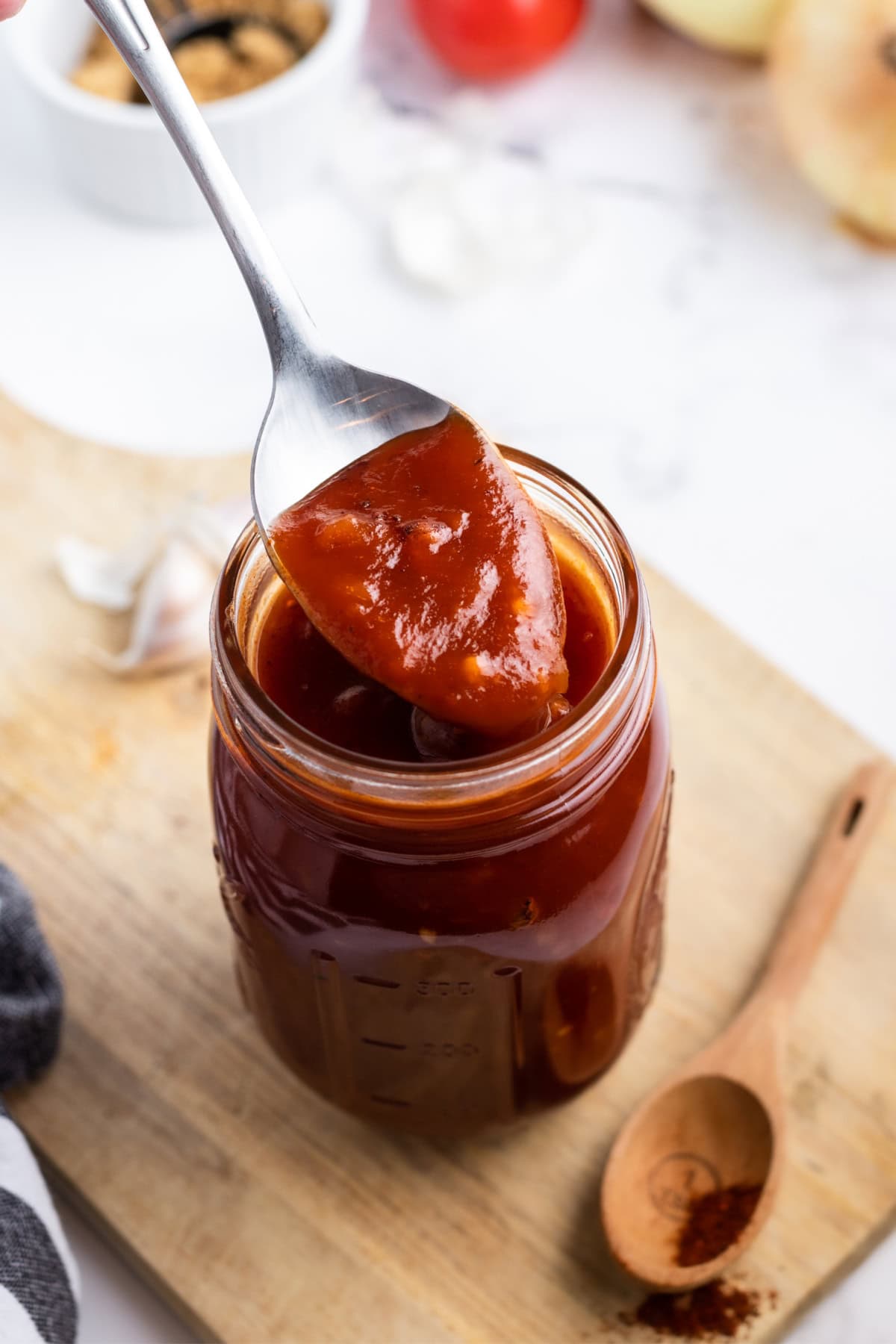Homemade Barbecue Sauce recipe from RecipeGirl.com : sweet barbecue sauce, BBQ Sauce, Smoky Barbecue sauce spoon in jar of homemade barbecue sauce