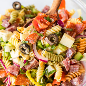 antipasto pasta salad in bowl with spoon
