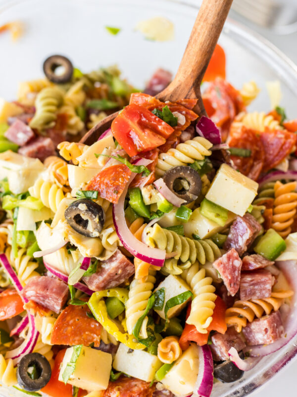 antipasto pasta salad in bowl with spoon