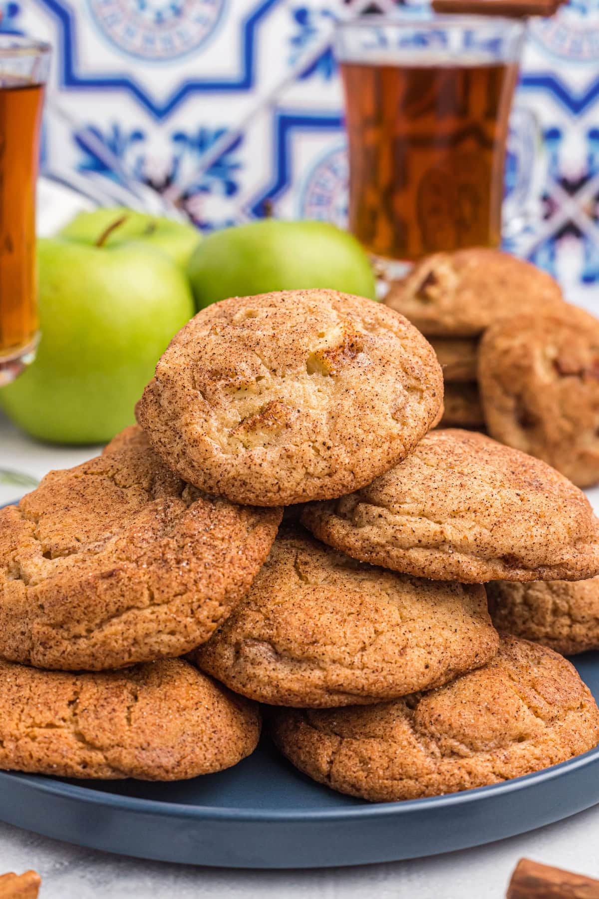 Apple Snickerdoodles are traditional snickerdoodles filled with apple cider syrup and fresh apples to create the perfect fall cookie recipe. Recipe from RecipeGirl.com apple snickerdoodles displayed on a platter
