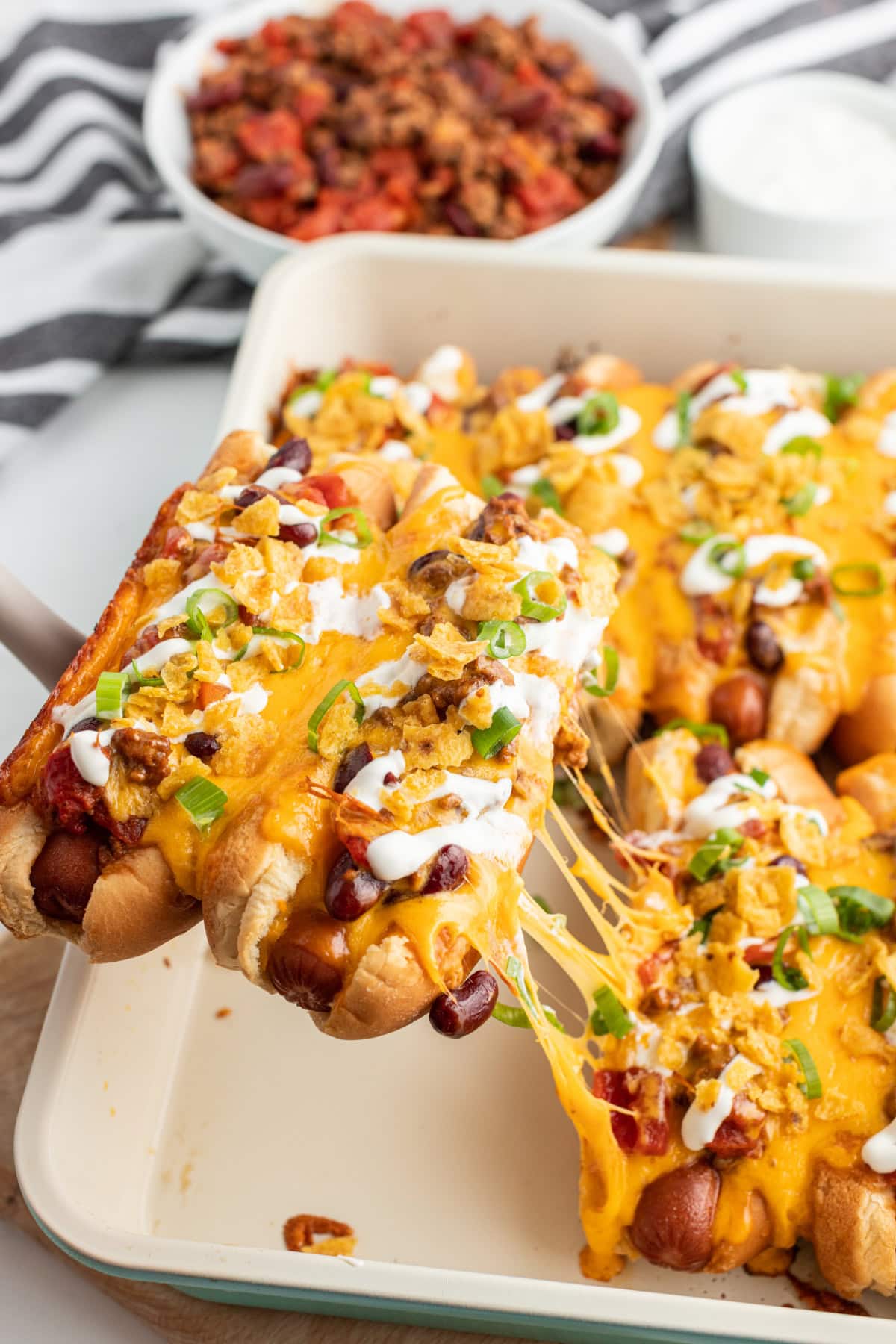 taking baked chili dogs out of casserole dish