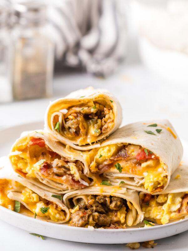 stack of breakfast burritos on a plate