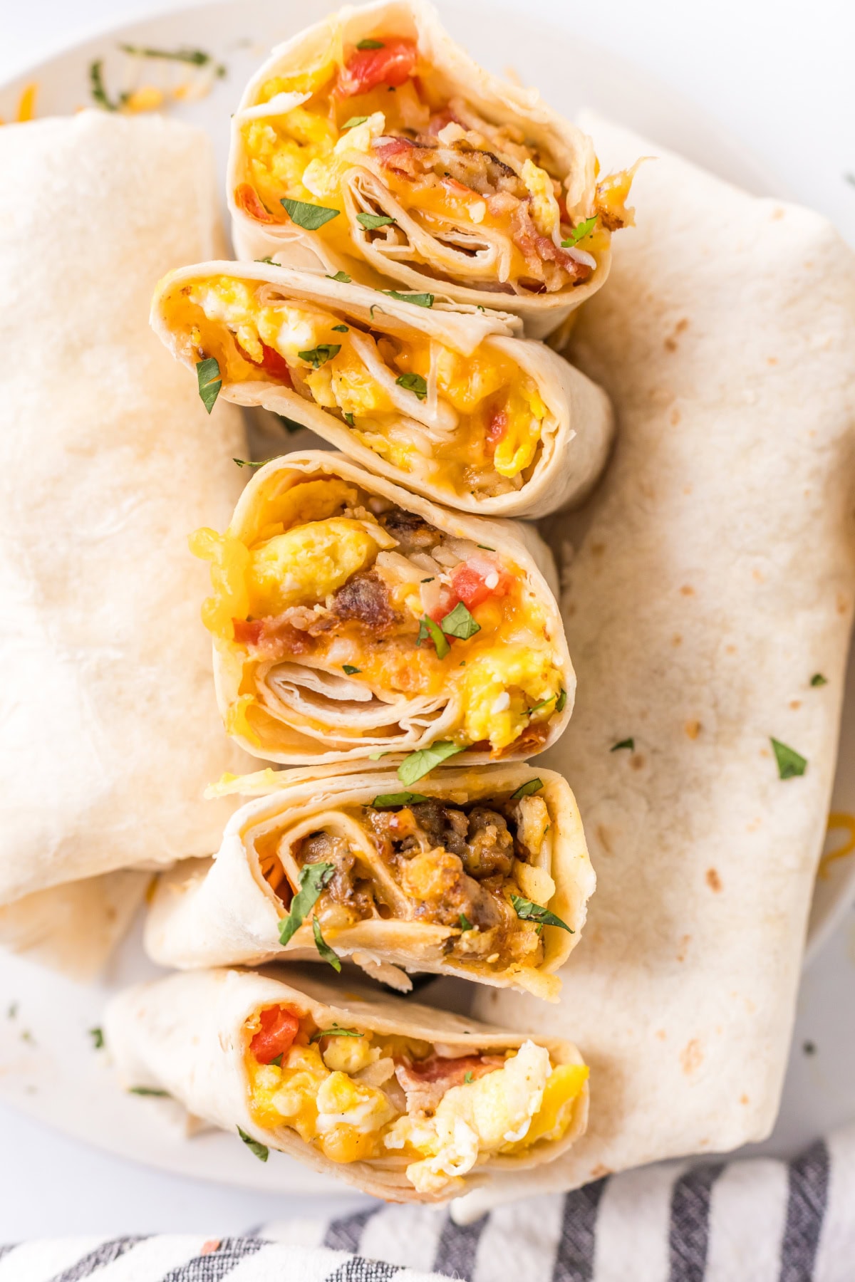How to make Breakfast Burritos recipe from RecipeGirl.com : scrambled eggs, sausage, hash browns and cheese several breakfast burritos