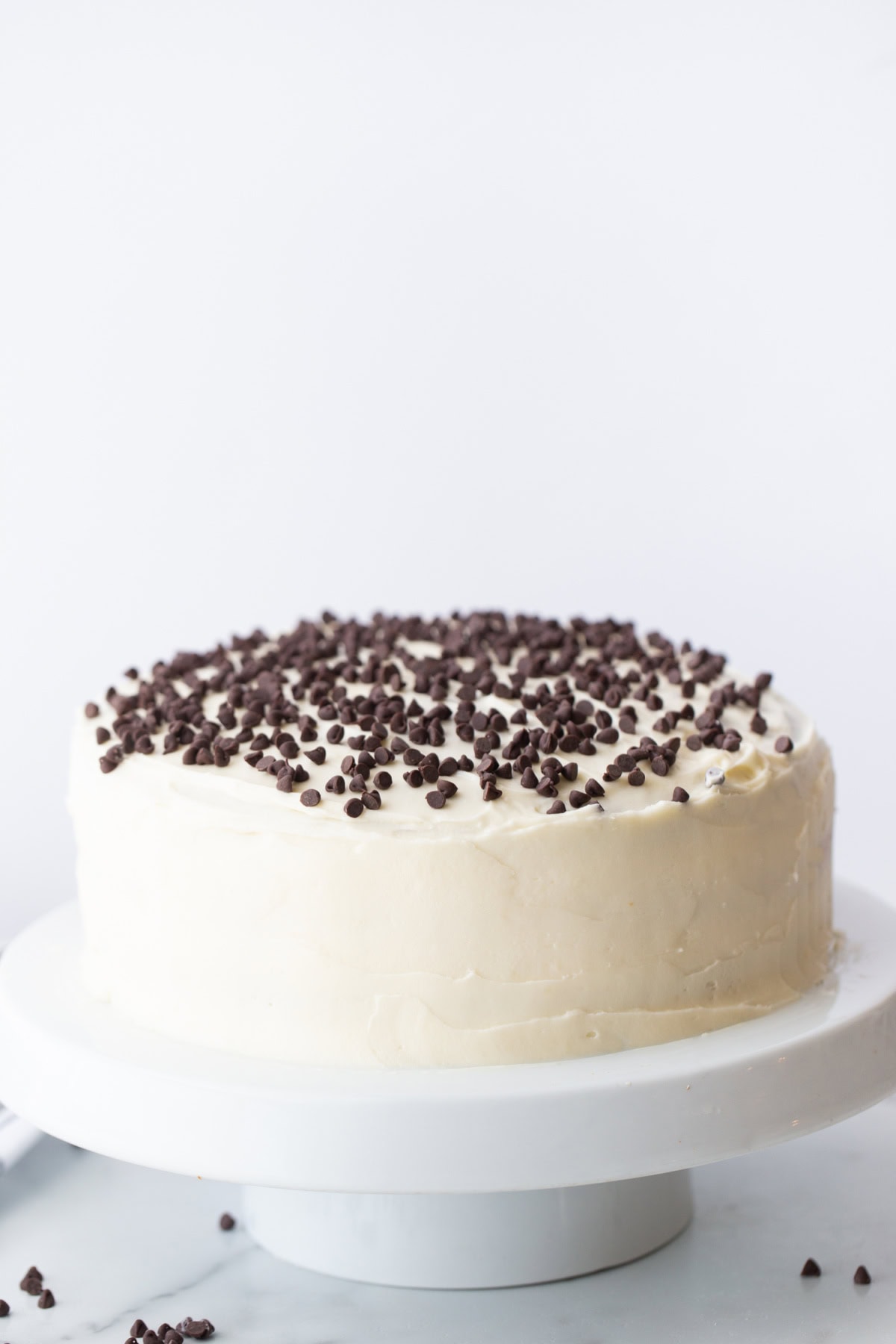 Chocolate Chip Cheesecake Cake recipe from RecipeGirl.com chocolate chip cheesecake cake on a cake stand