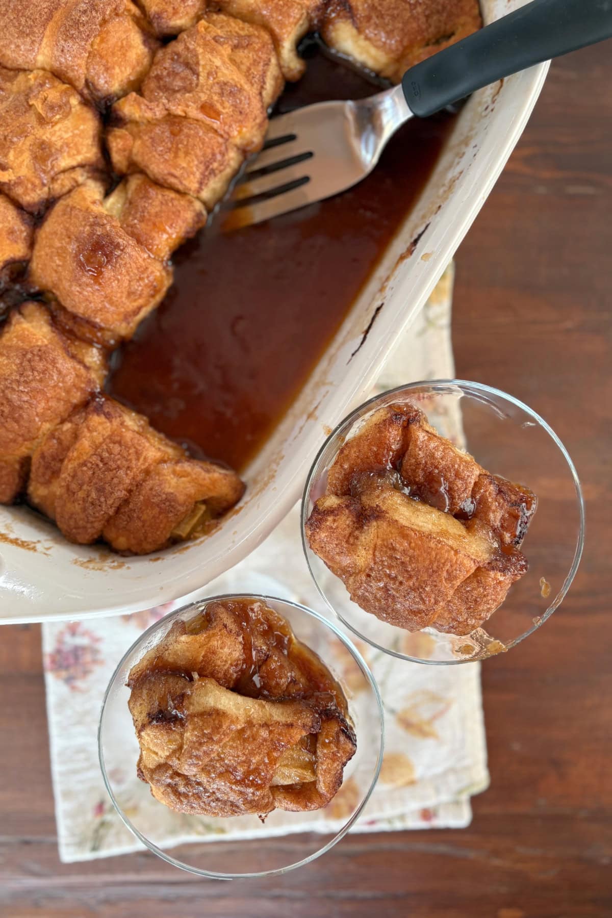 baking dish of crescent apple dumplings with two servings in dishes