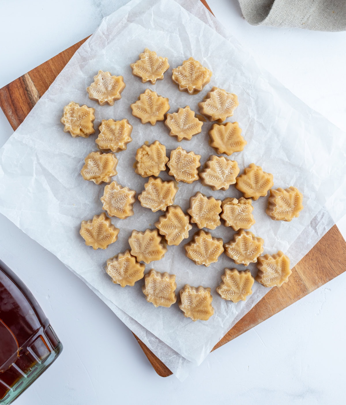 These Maple Syrup Candies are made with only one ingredient: pure maple syrup! Make them in maple leaf molds for cute results. Recipe from RecipeGirl.com. overhead shot of several pieces of maple candy