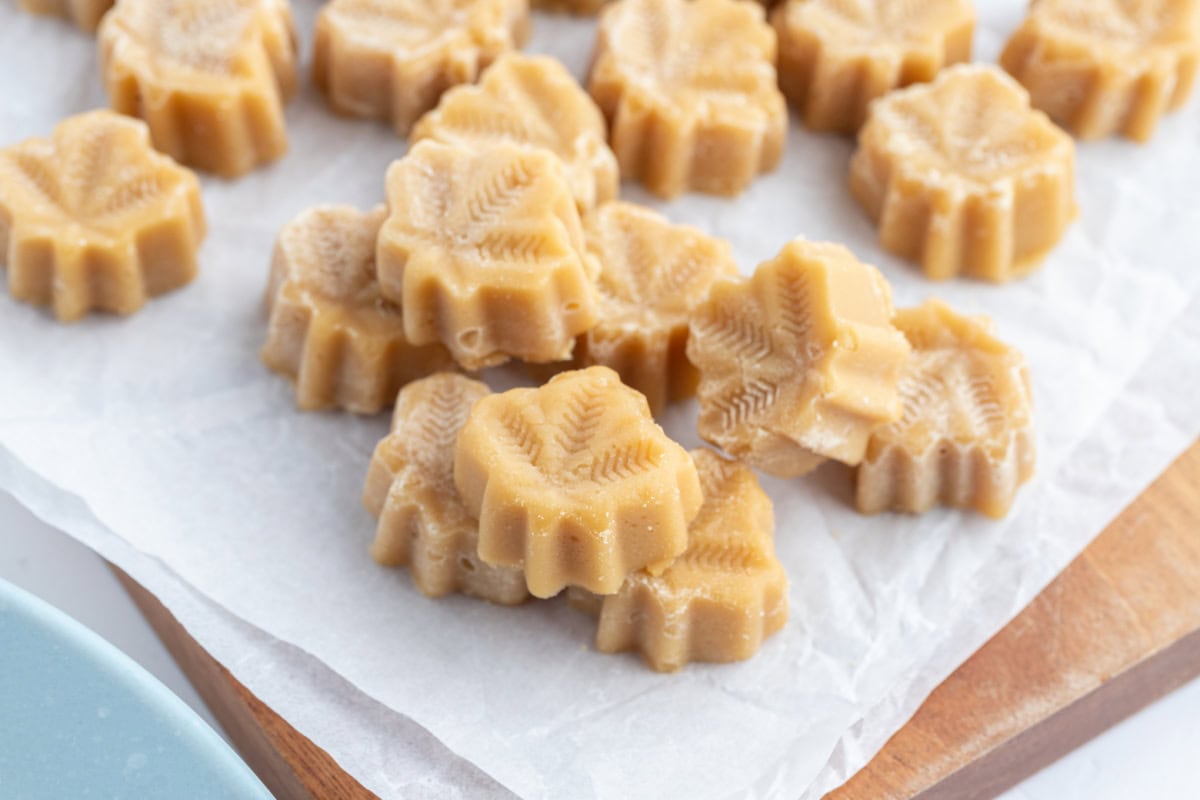 These Maple Syrup Candies are made with only one ingredient: pure maple syrup! Make them in maple leaf molds for cute results. Recipe from RecipeGirl.com. maple candy on a parchment lined board