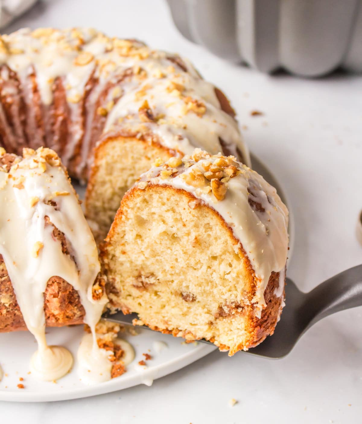 maple coffee cake with slice coming out of it