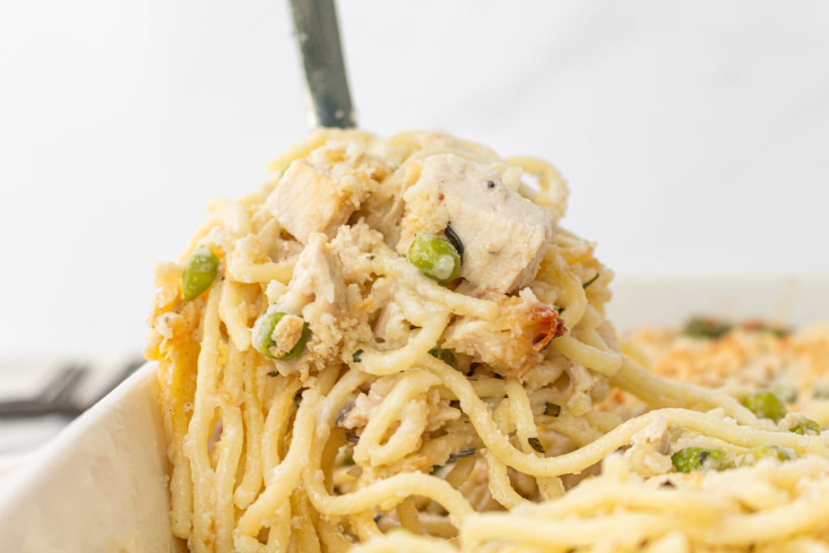 Chicken Tetrazzini is a great-tasting, creamy comfort food casserole, and there are no canned condensed soups used in this recipe! Recipe from RecipeGirl.com. spooning chicken tetrazzini out of pan