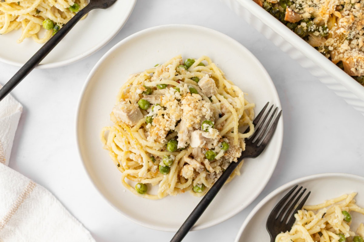 Chicken Tetrazzini is a great-tasting, creamy comfort food casserole, and there are no canned condensed soups used in this recipe! Recipe from RecipeGirl.com. serving of chicken tetrazzini on plate