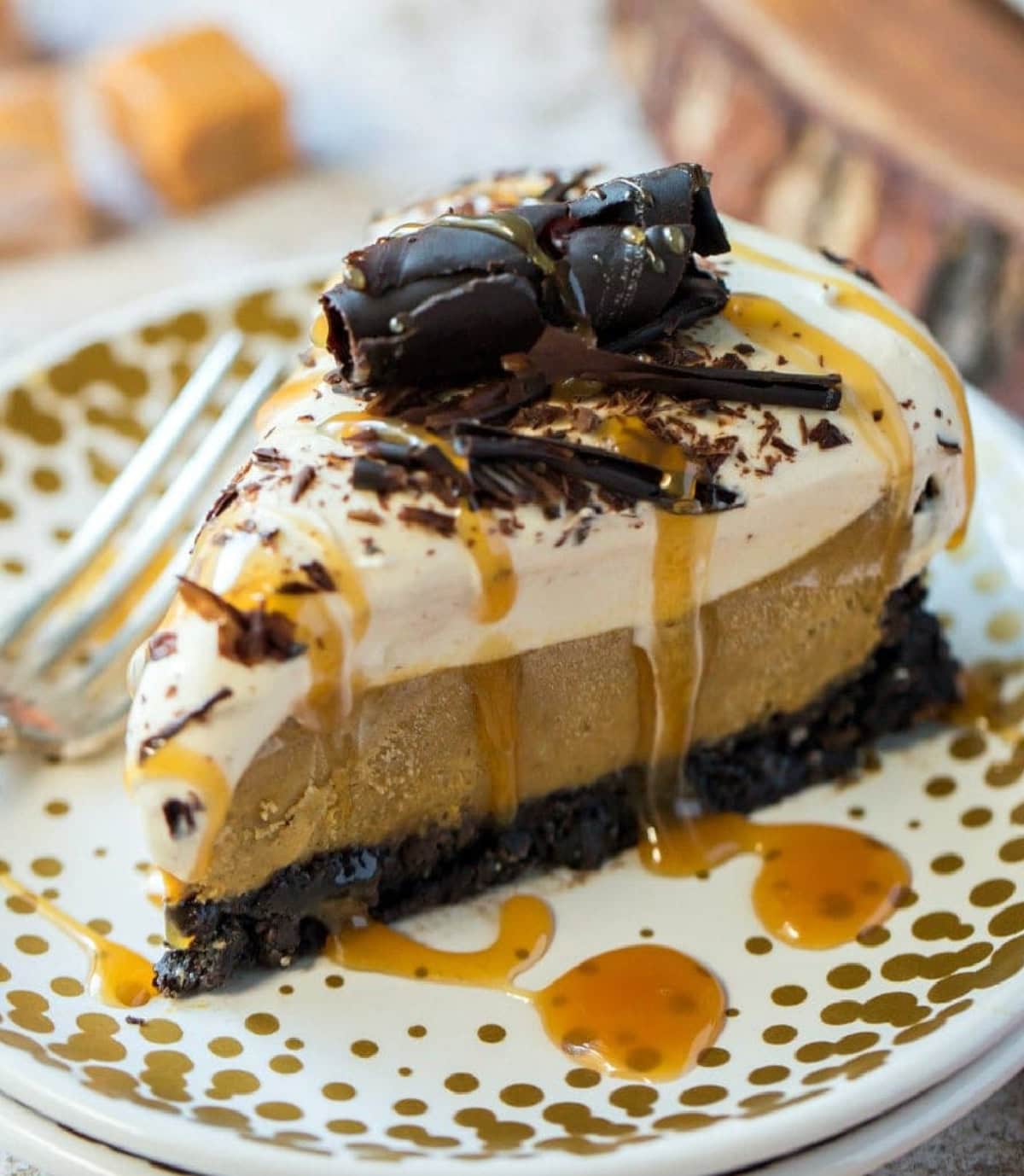 This Double Decker Pumpkin Caramel Pie is so good that it has been a pie contest blue ribbon winner! slice of pumpkin caramel pie on a plate
