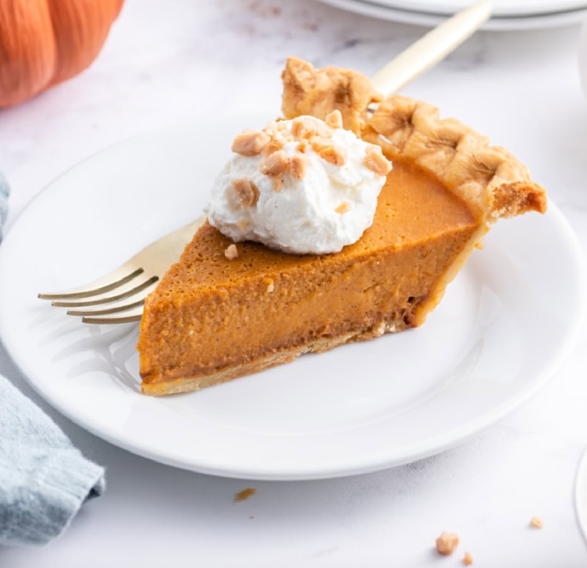 This is a rich and delicious pumpkin pie recipe. slice of pumpkin pie on a plate