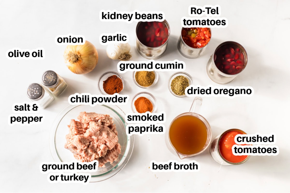 This Easy Slow Cooker Chili is the ultimate comfort food — loaded with ground beef or turkey, beans, and bold spices. A simple, hearty meal that’s perfect for cozy nights, game days, or meal prep! ingredients displayed for making easy slow cooker chili