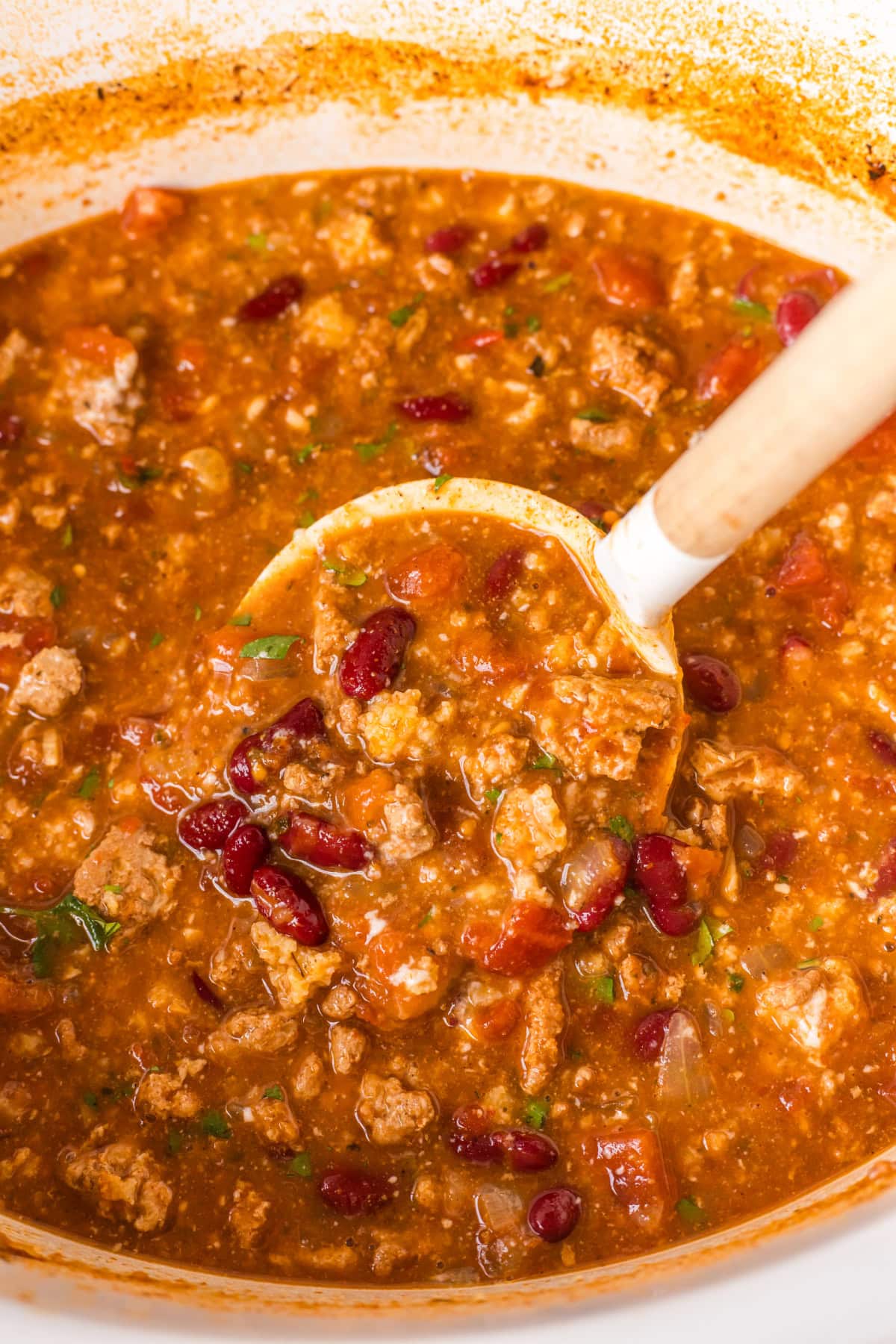 This Easy Slow Cooker Chili is the ultimate comfort food — loaded with ground beef or turkey, beans, and bold spices. A simple, hearty meal that’s perfect for cozy nights, game days, or meal prep! Ground turkey chili in a slow cooker with beans and tomatoes