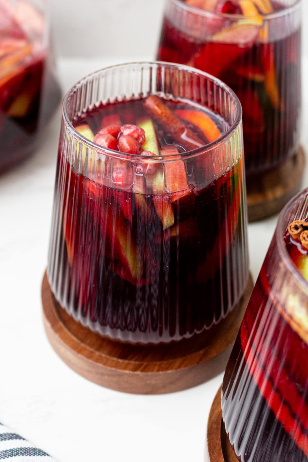 This sangria has all of the flavors of fall! Recipe from RecipeGirl.com. glass of fall sangria