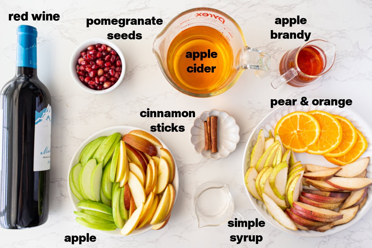 This sangria has all of the flavors of fall! Recipe from RecipeGirl.com. ingredients displayed for making fall sangria