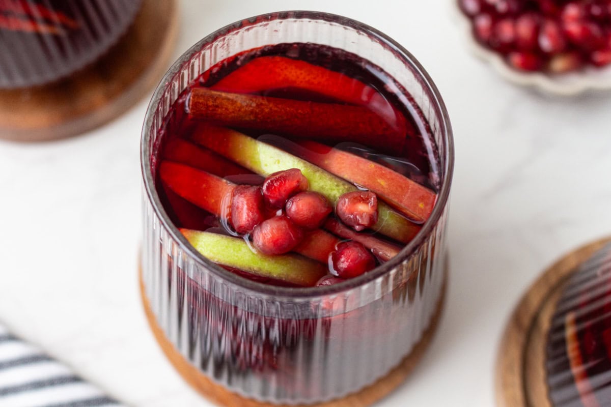 This sangria has all of the flavors of fall! Recipe from RecipeGirl.com. looking into a glass of fall sangria