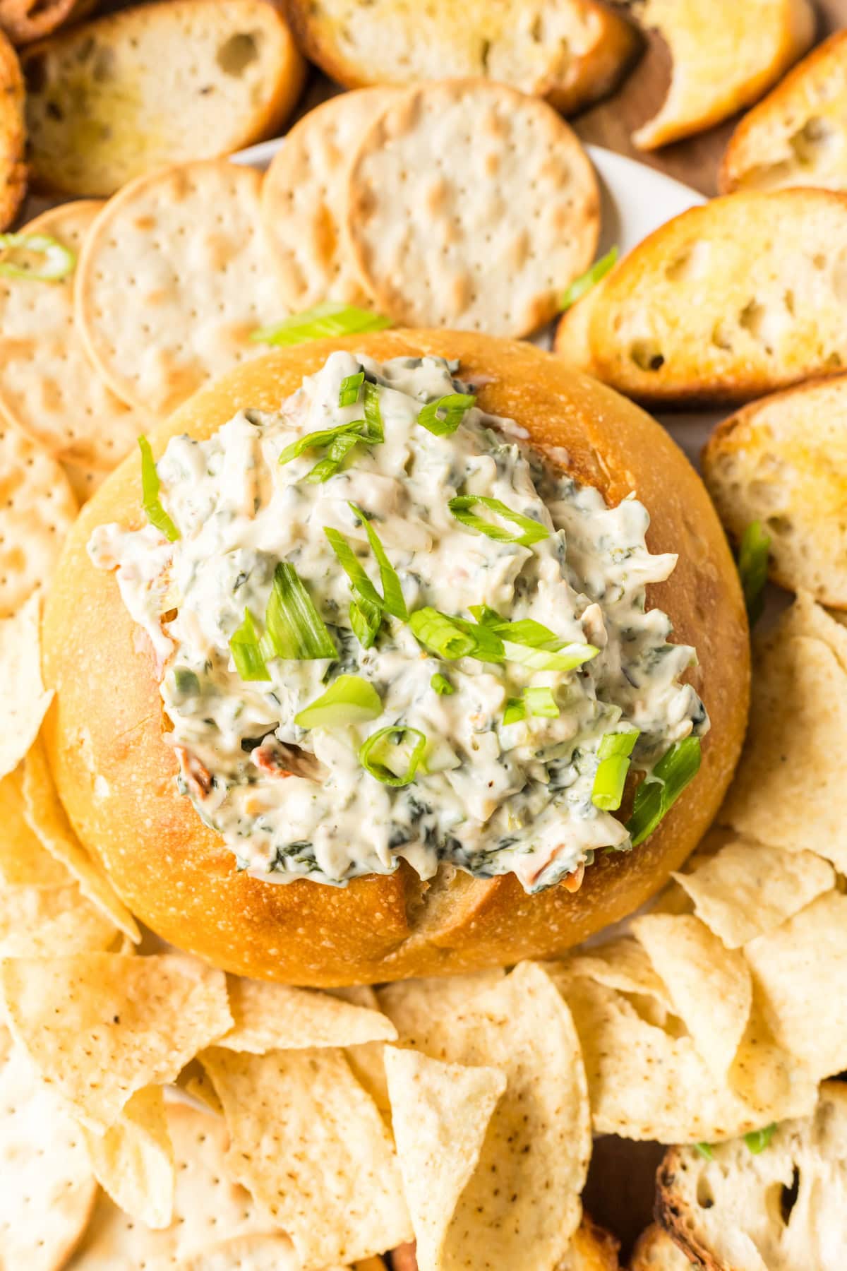 This Knorr Spinach Dip in a bread bowl is creamy, classic, and easy! A timeless appetizer perfect for holidays, game day, or parties. Recipe on RecipeGirl.com. bread bowl full of knorr spinach dip