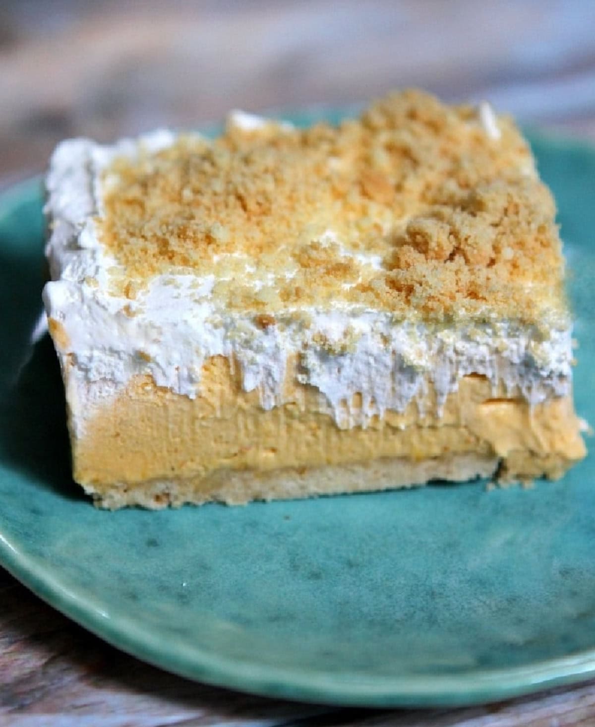 No Bake Pumpkin Shortbread Bars are a wonderful, easy fall dessert recipe with a shortbread cookie crust, creamy pumpkin filling and whipped topping on top. no bake pumpkin shortbread bar on a plate