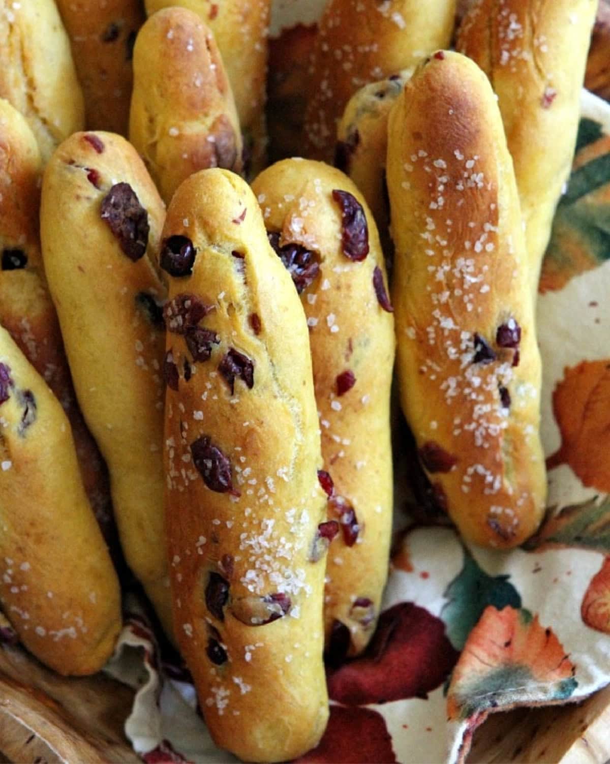 Pumpkin- Cranberry Breadsticks are tender and chewy… soft on the inside and slightly crispy on the outside. several pumpkin cranberry breadsticks