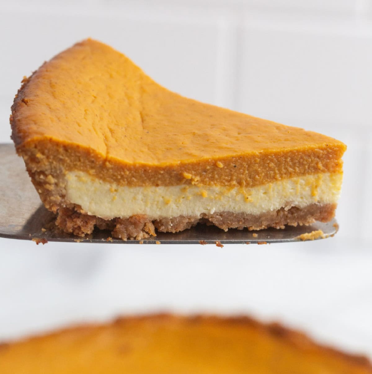 Pumpkin Cream Cheese Pie is a delicious way to jazz up a traditional pumpkin pie. slice of pumpkin cream cheese pie