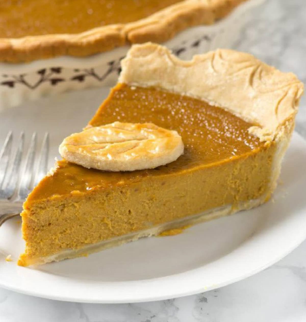 The peanut butter in the pie just helps create a beautiful texture for the pie (it doesn't take over the flavor). slice of pumpkin peanut butter pie on a plate