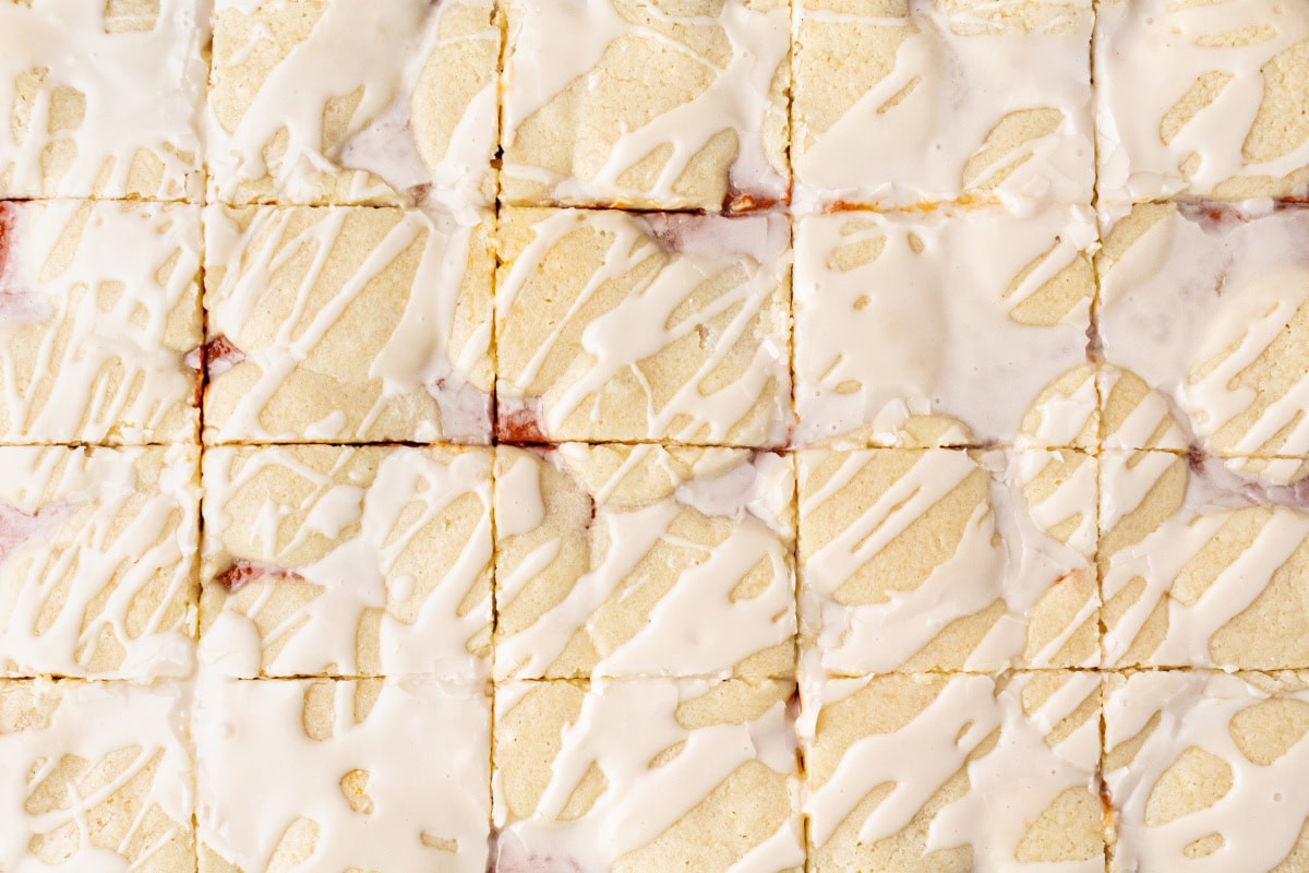These Pumpkin Bars are delicious with pumpkin filling surrounded by two layers of flaky, buttery, sweet crust! Recipe from RecipeGirl.com. pumpkin bars cut into pieces overhead shot