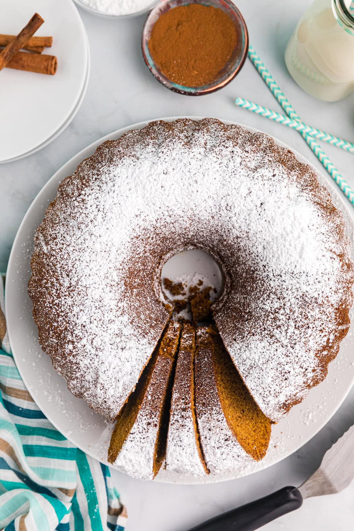 Delicious, moist, and spiced to perfection — this Pumpkin Pound Cake is the fall dessert everyone will be asking for again and again. Recipe from RecipeGirl.com. pumpkin pound cake overhead shot with slices cut