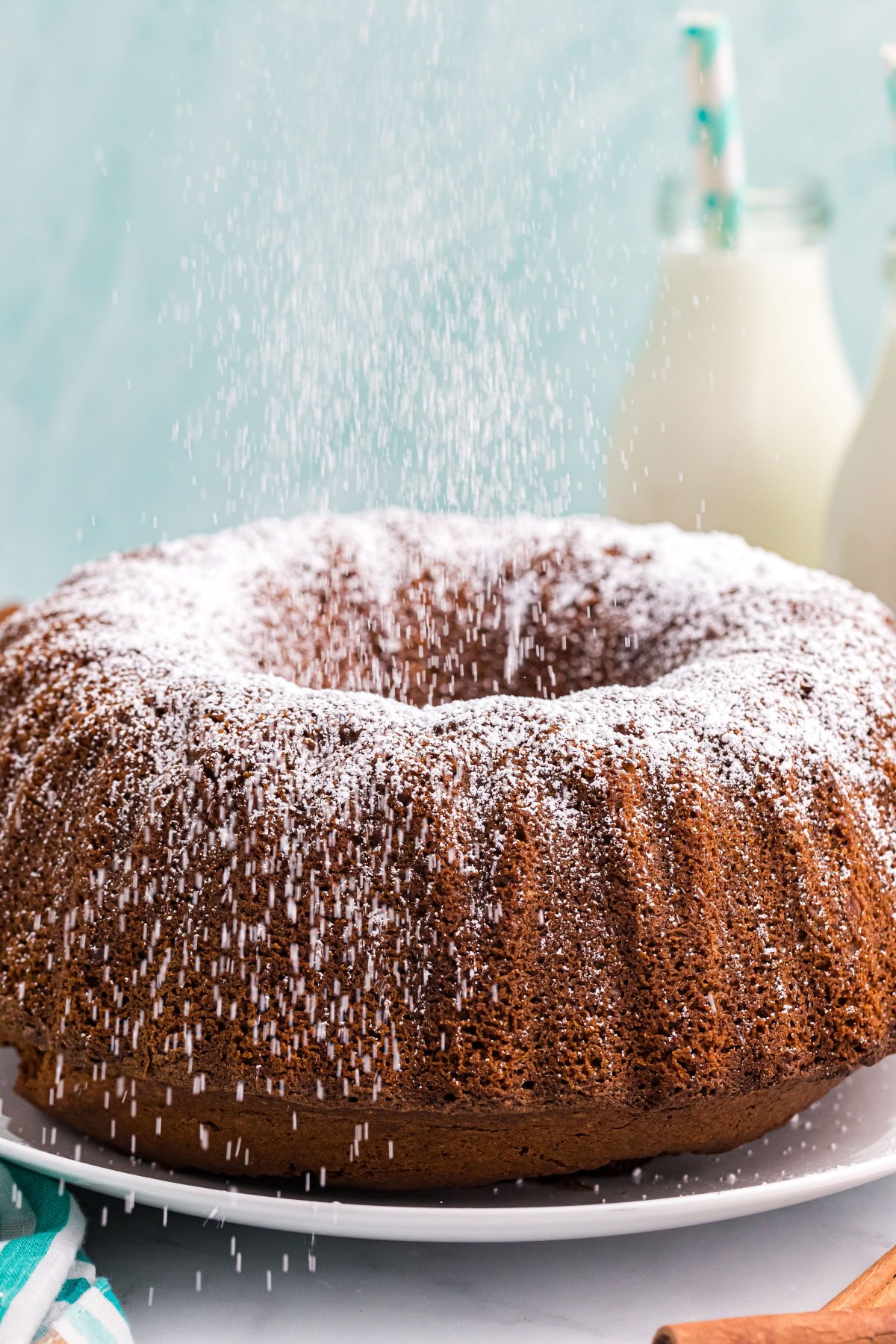 Delicious, moist, and spiced to perfection — this Pumpkin Pound Cake is the fall dessert everyone will be asking for again and again. Recipe from RecipeGirl.com. pumpkin pound cake with powdered sugar shaking over it