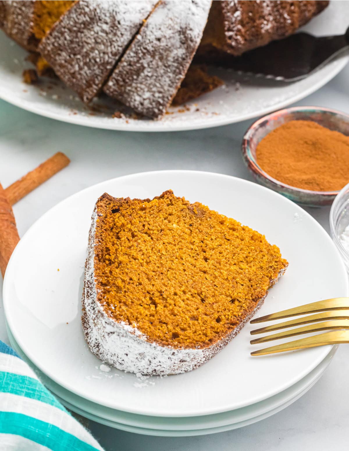 Delicious, moist, and spiced to perfection — this Pumpkin Pound Cake is the fall dessert everyone will be asking for again and again. Recipe from RecipeGirl.com. slice of pumpkin pound cake on plate