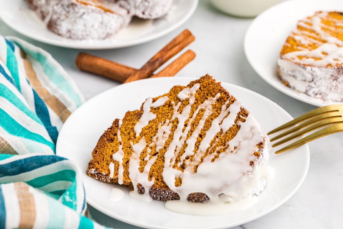 Delicious, moist, and spiced to perfection — this Pumpkin Pound Cake is the fall dessert everyone will be asking for again and again. Recipe from RecipeGirl.com. serving of pumpkin pound cake on plate with fork
