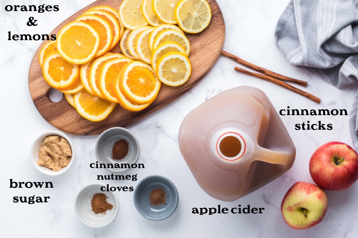 Slow Cooker Mulled Cider is the ultimate perfect warm, non-alcoholic apple cider beverage to make and enjoy during the fall and winter months. Recipe from RecipeGirl.com. ingredients displayed for making slow cooker mulled cider