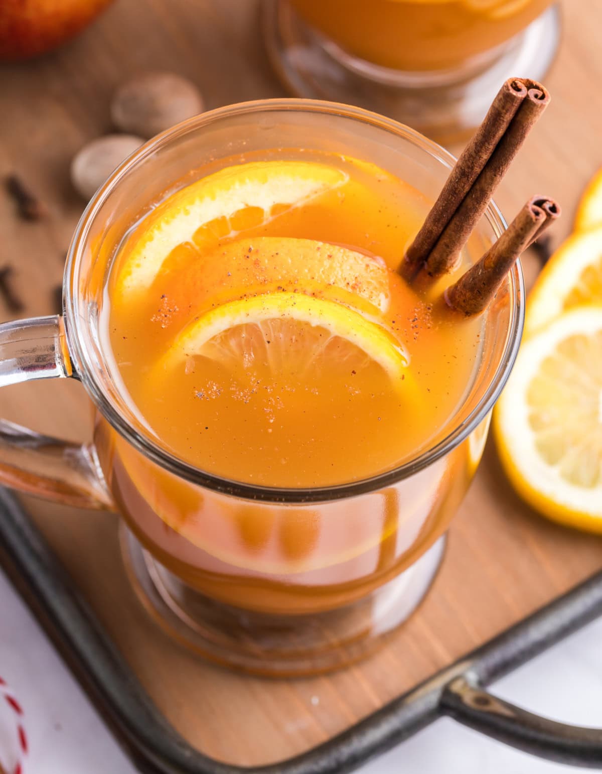 Slow Cooker Mulled Cider is the ultimate perfect warm, non-alcoholic apple cider beverage to make and enjoy during the fall and winter months. Recipe from RecipeGirl.com. looking into a mug of slow cooker mulled cider