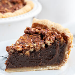 slice of bourbon chocolate pecan pie on a plate